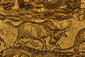 Luang Prabang, Laos - Wat Mai the gilded stucco engravings of the veranda. They narrate the Vessantara Jataka with various animals engraved at the base of the relief. 
